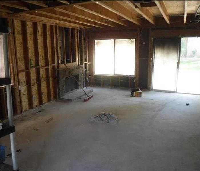 A living room with bare walls down to the studs.
