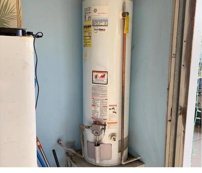 A rusted water heater that has been leaking. 